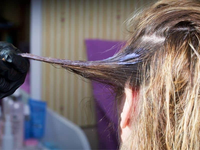 woman doing a hair dye strand test