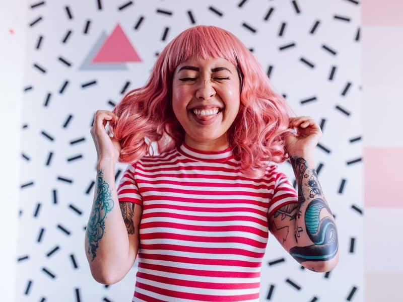 girl with dyed pink hair looking cool and having fun