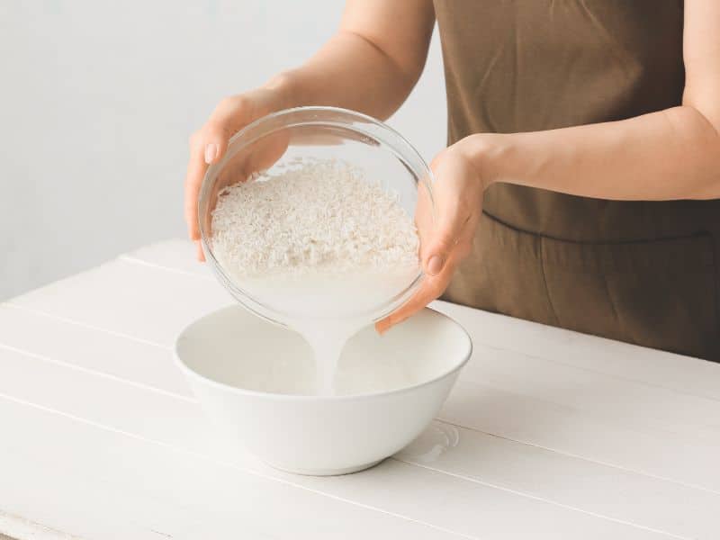 Can You Use Rice Water on Color-Treated Hair- straining rice water into a bowl