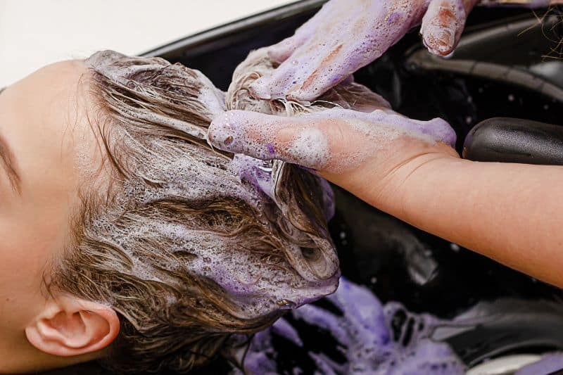 Can You Tone Your Hair Twice - purple toner shampooing in a hair salon