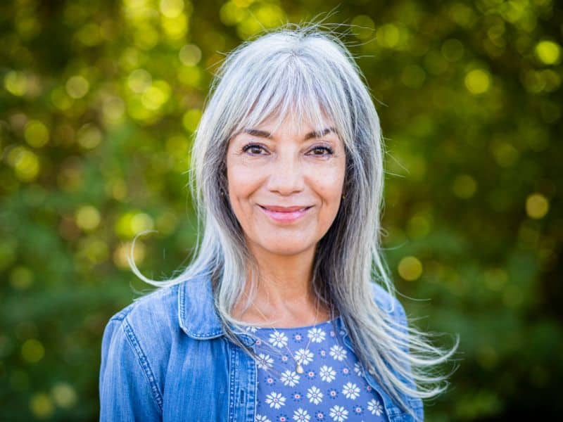 happy lady with gorgeous grown-out gray silver hair