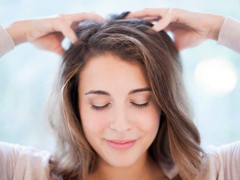 Weekly Hair Care Routine - woman giving herself a scalp massage